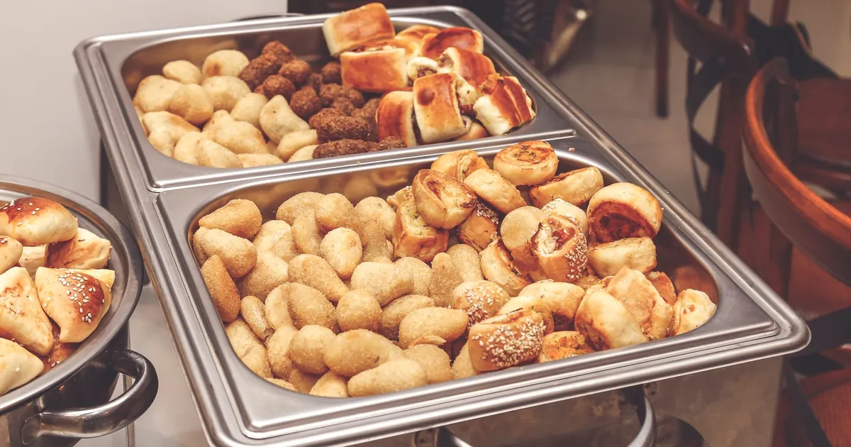 Chafing dishes of pastries on a catering buffet